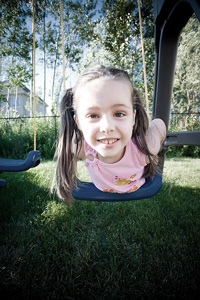 photo of young girl on swing